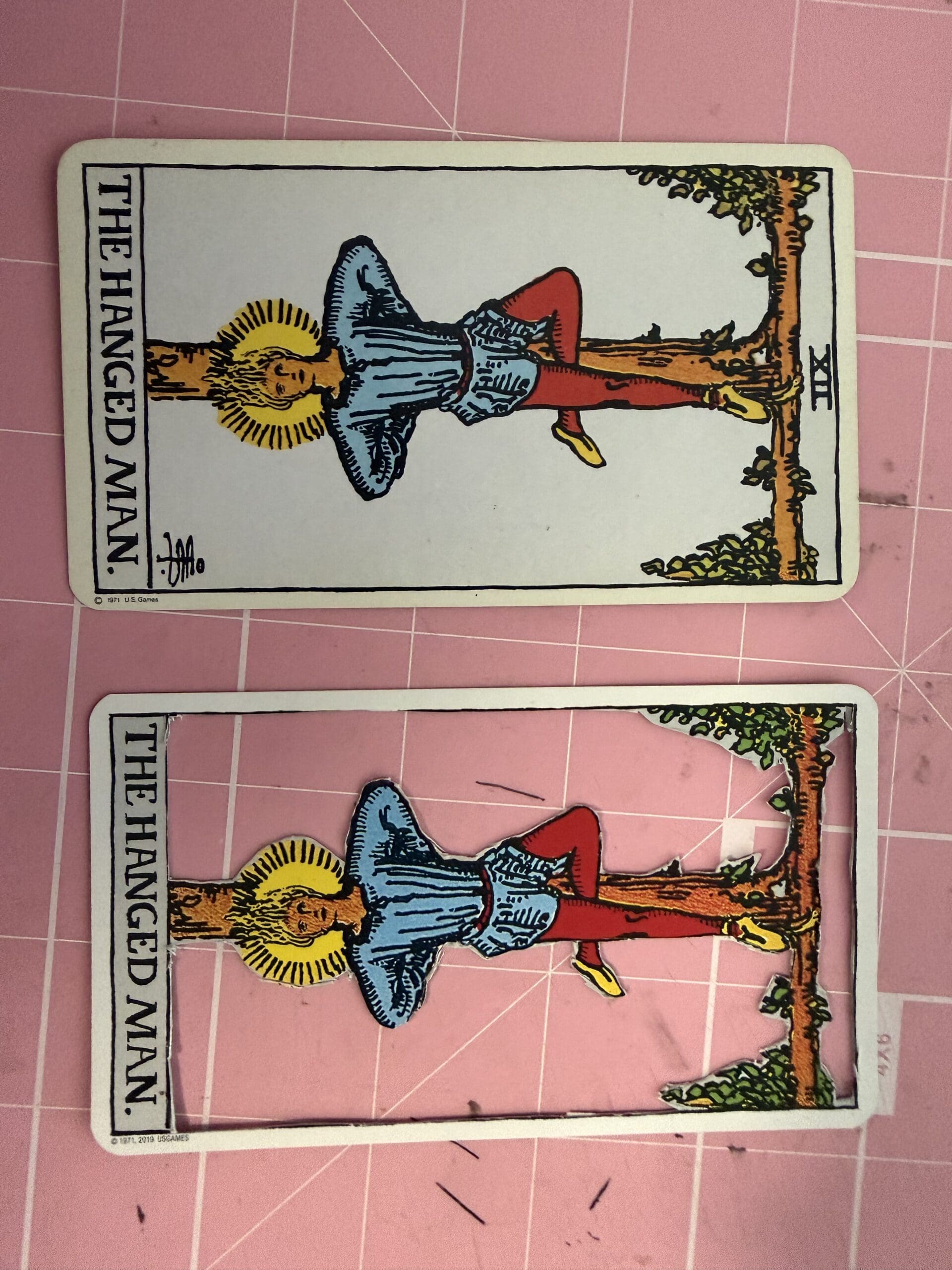 Hanged Man tarot card showing original and cutout layers during handcrafted process