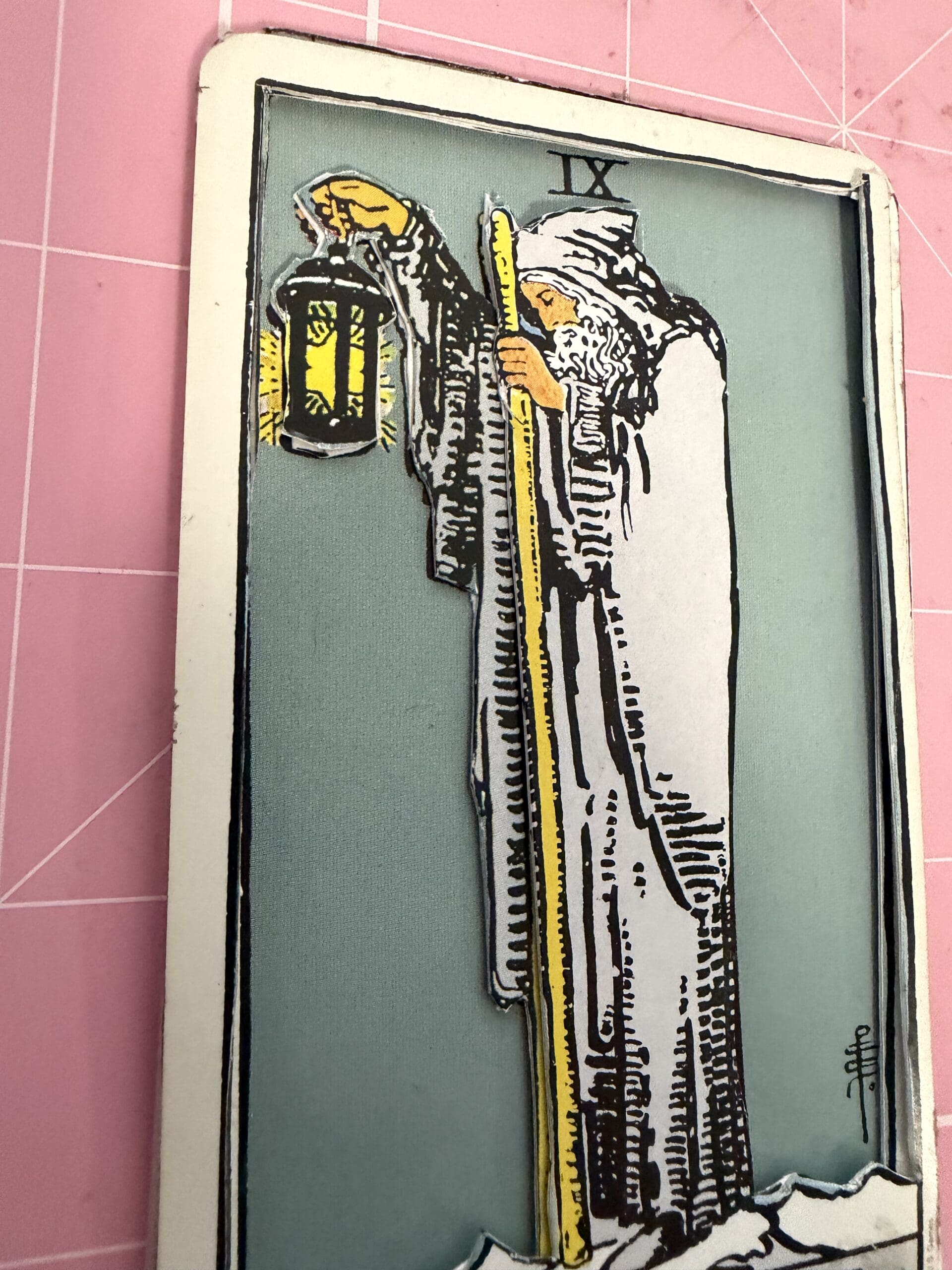 The Hermit tarot card showing layered 3D handcrafted detail with lantern
